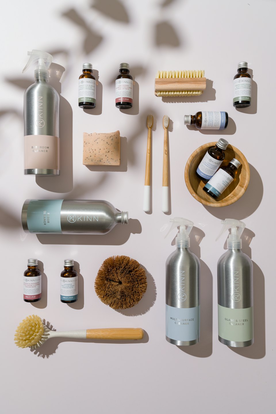 Eco-friendly cleaning supplies laid out on a white surface.